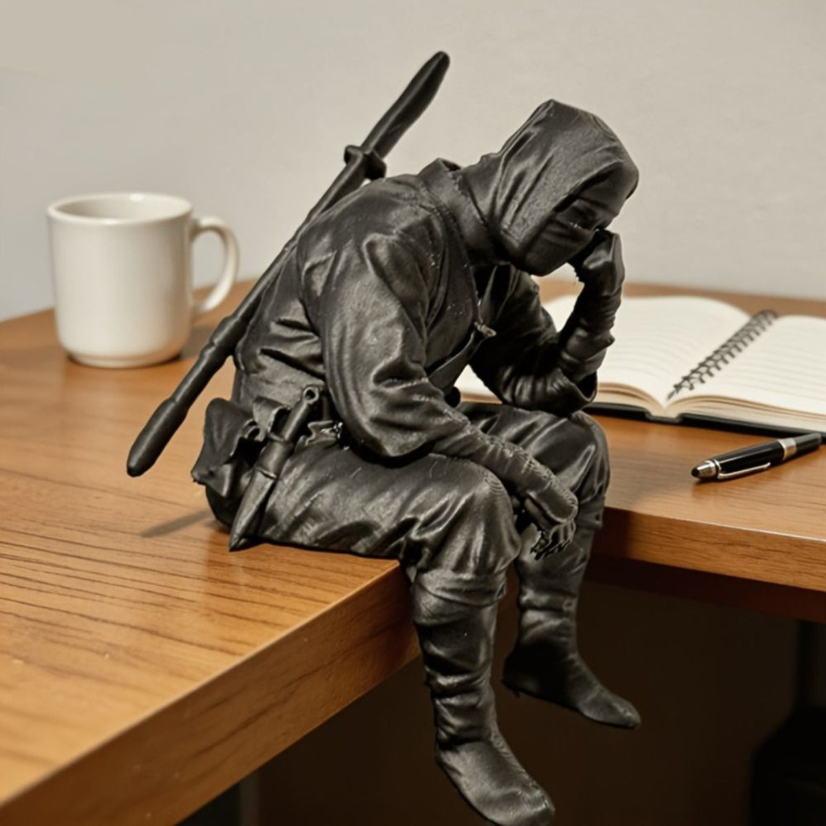 Thinking Ninja on a desk beside a notebook and pen