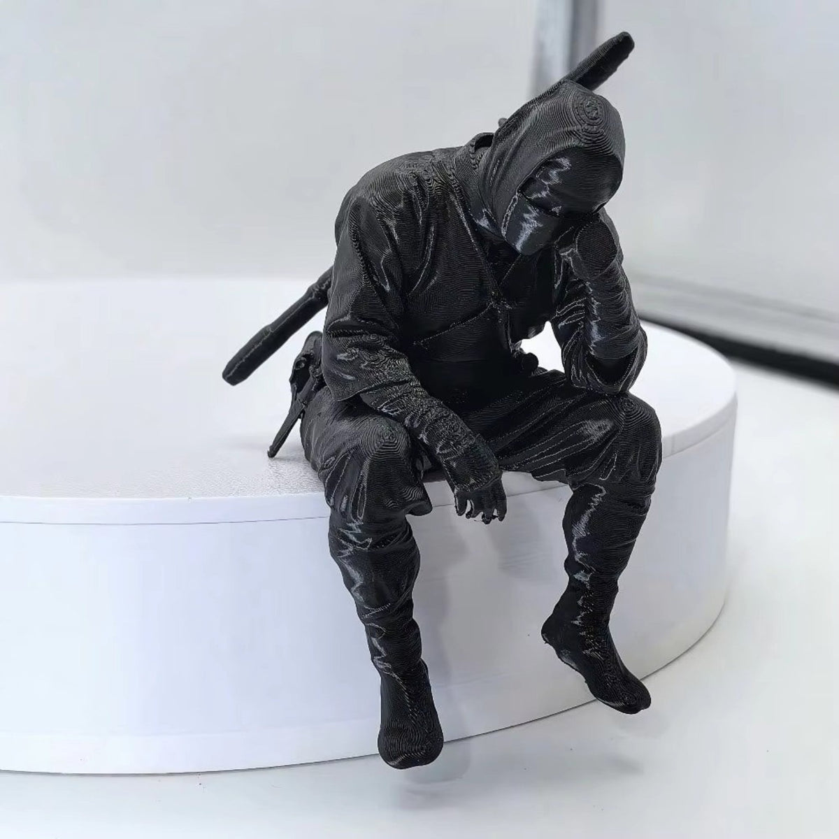 Thinking Ninja figure seated on a white shelf