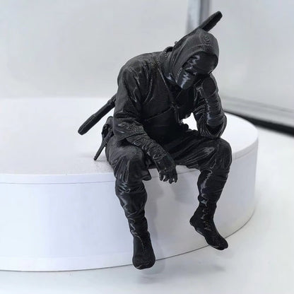 Thinking Ninja figure seated on a white shelf