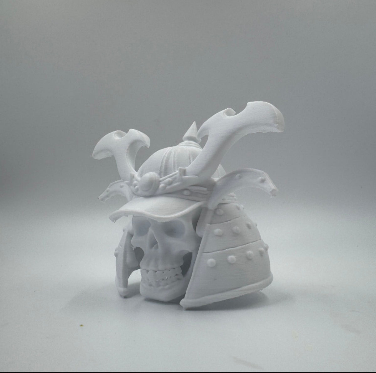 White samurai skull wearing an ornate helmet, three-quarter view
