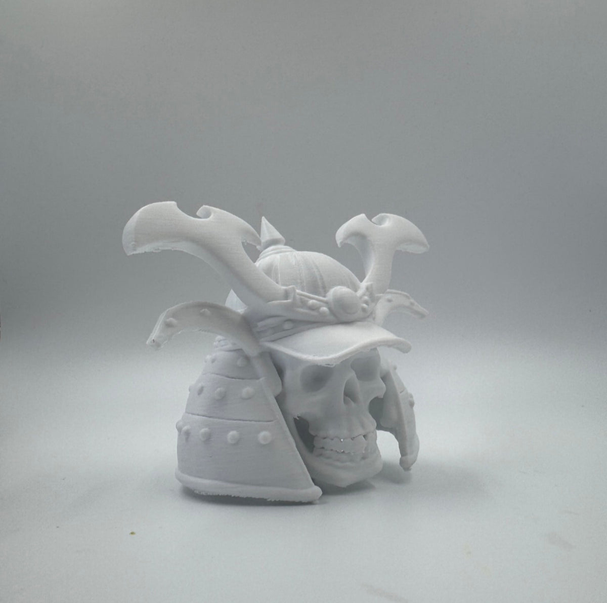 White samurai helmet skull figure from an alternate angle