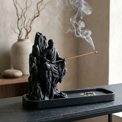 Zen monk incense holder seated on a dark mountain with curling incense smoke