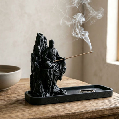 Zen monk mountain incense holder on a natural wood table
