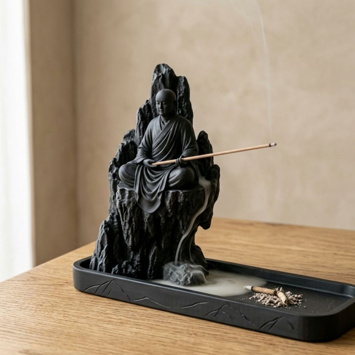 Close view of the seated monk and mountain incense holder
