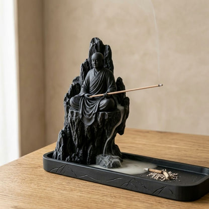 Close view of the seated monk and mountain incense holder
